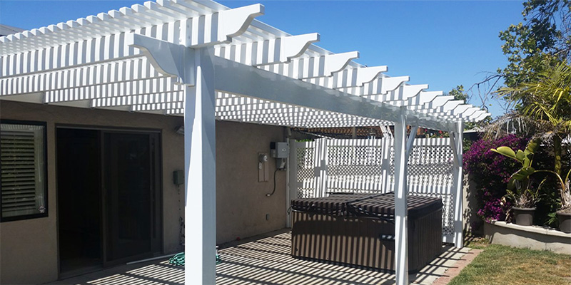 Close up of white Ventura outdoor patio cover placed over a closed spa unit.
