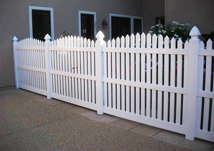 White scalloped picket fencing, an example of our Sanger premium PVC fences.
