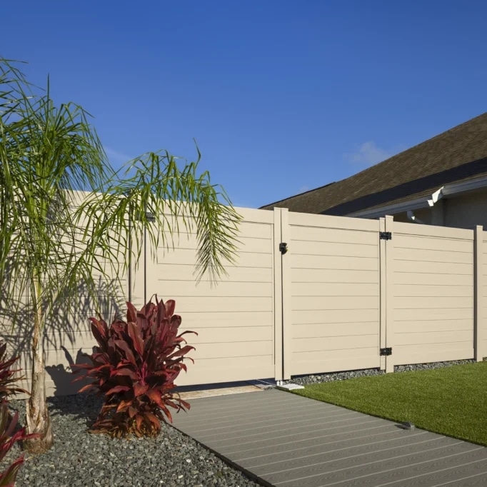 Tan horizontal vinyl privacy fencing & gate to be paired with Port Hueneme non combustible fence materials.
